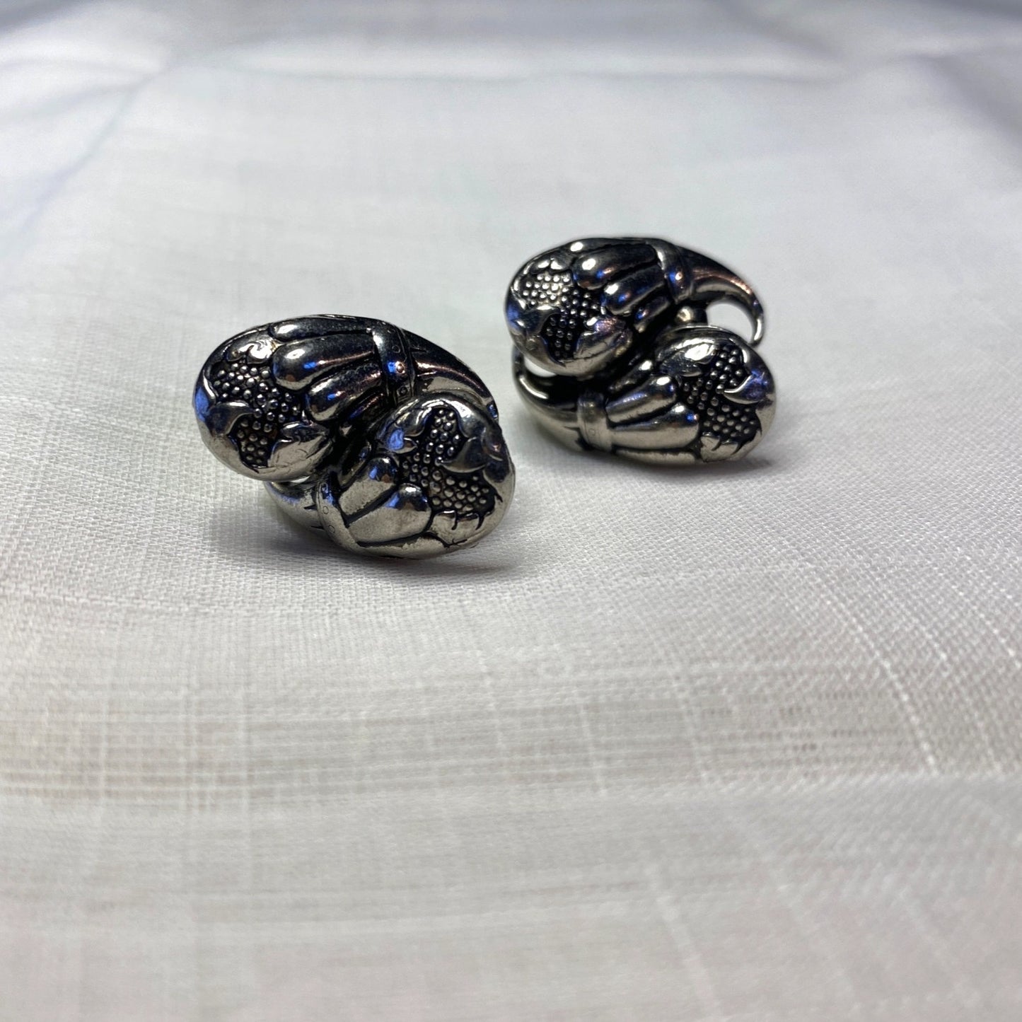 Vintage Silver-Toned Floral Clip-On Earrings With Textured Design And Elegant Detailing